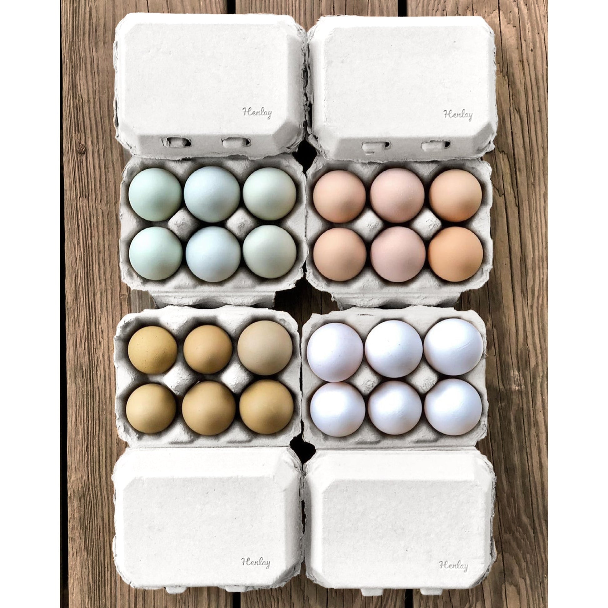 Six-pack of Henlay blank flat top egg cartons in tan, designed for six eggs, available in 20 or 100 count options.