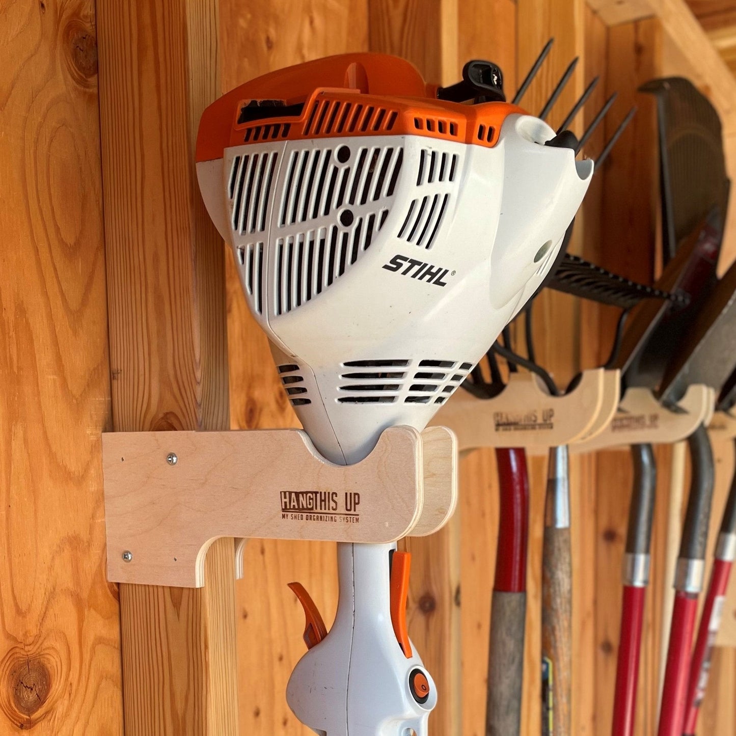 HangThis Up shed organization kit with garden tool rack, hooks, and shelving for outdoor yard and garden tool storage.