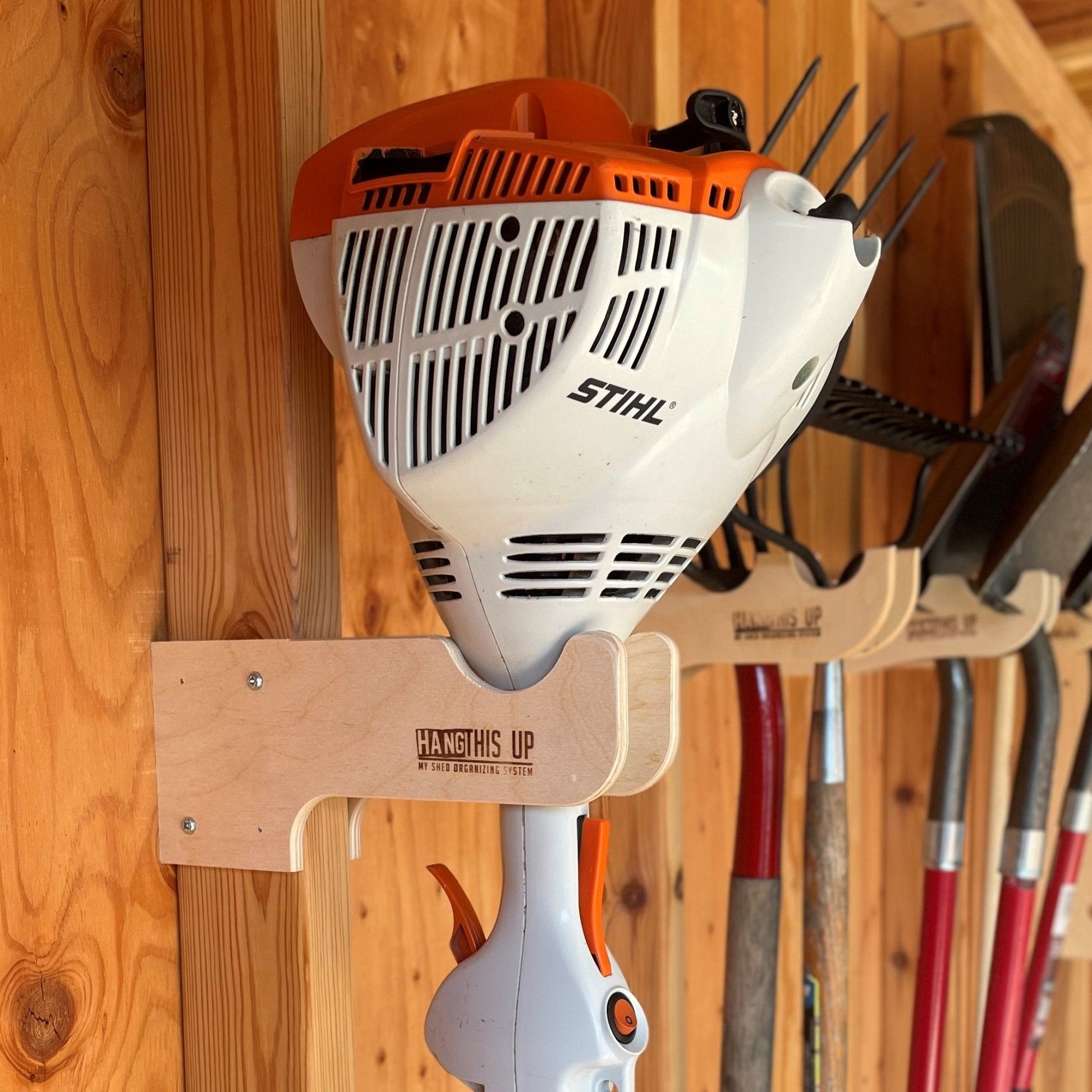 HangThis Up shed organization kit with garden tool rack, hooks, and shelving for outdoor yard and garden tool storage.