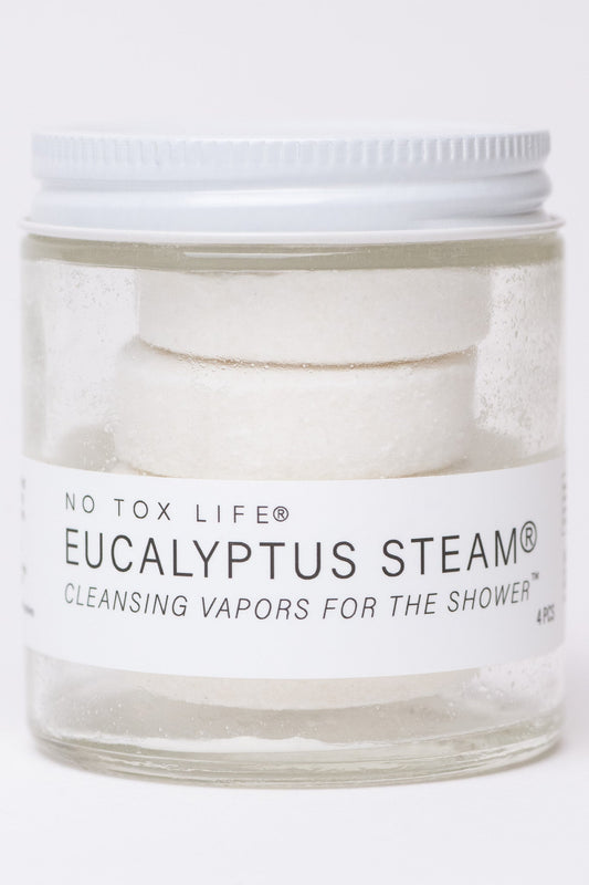 Mini jar of NO TOX LIFE Eucalyptus Steam® cleansing vapors for shower, featuring aromatic eucalyptus herbs in a small glass container.