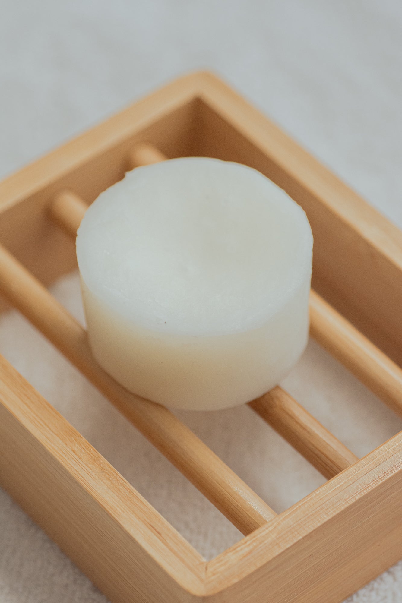 No Tox Life SOLIDSILK Delicate Volume Shampoo body bar in a natural setting, showcasing its packaging and product details.