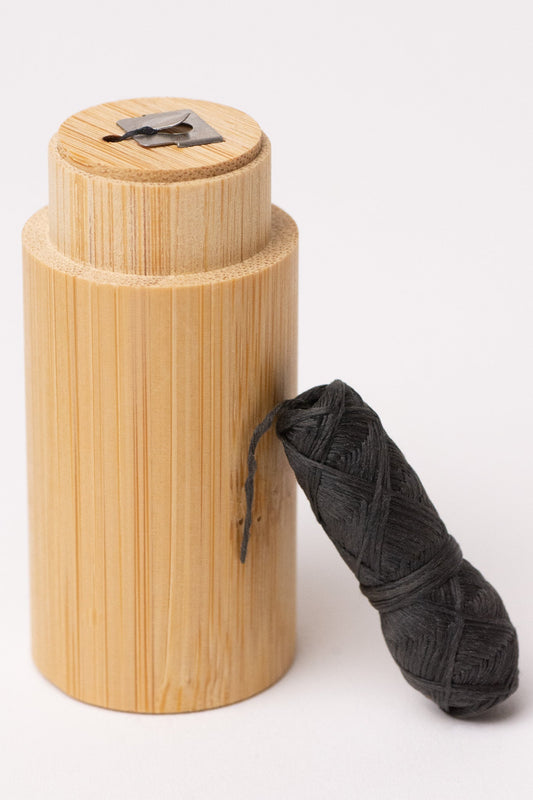 Charcoal floss with bamboo holder from NO TOX LIFE, eco-friendly dental floss in a natural bamboo container.