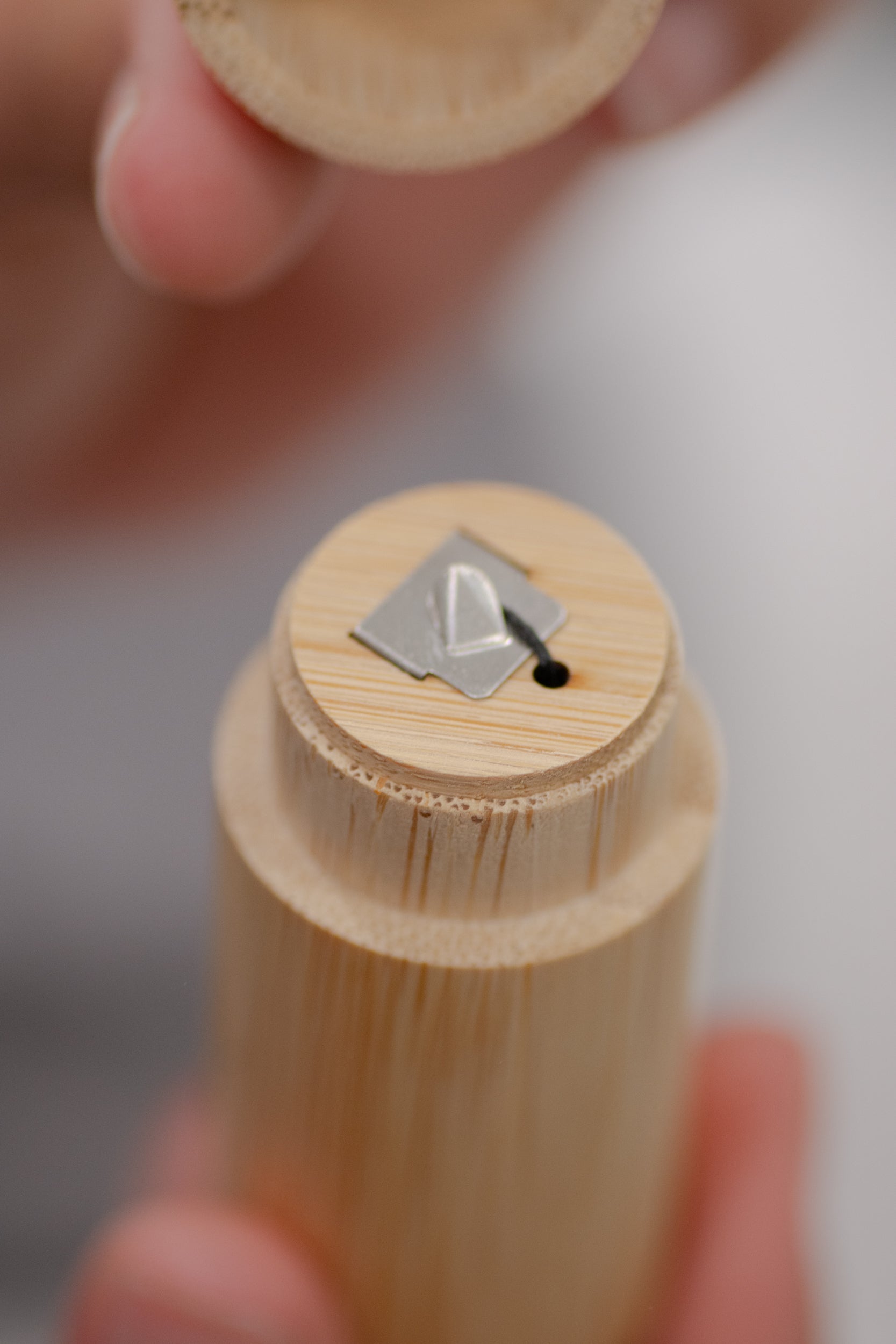Charcoal dental floss with bamboo holder from NO TOX LIFE, eco-friendly bamboo container for sustainable oral hygiene.