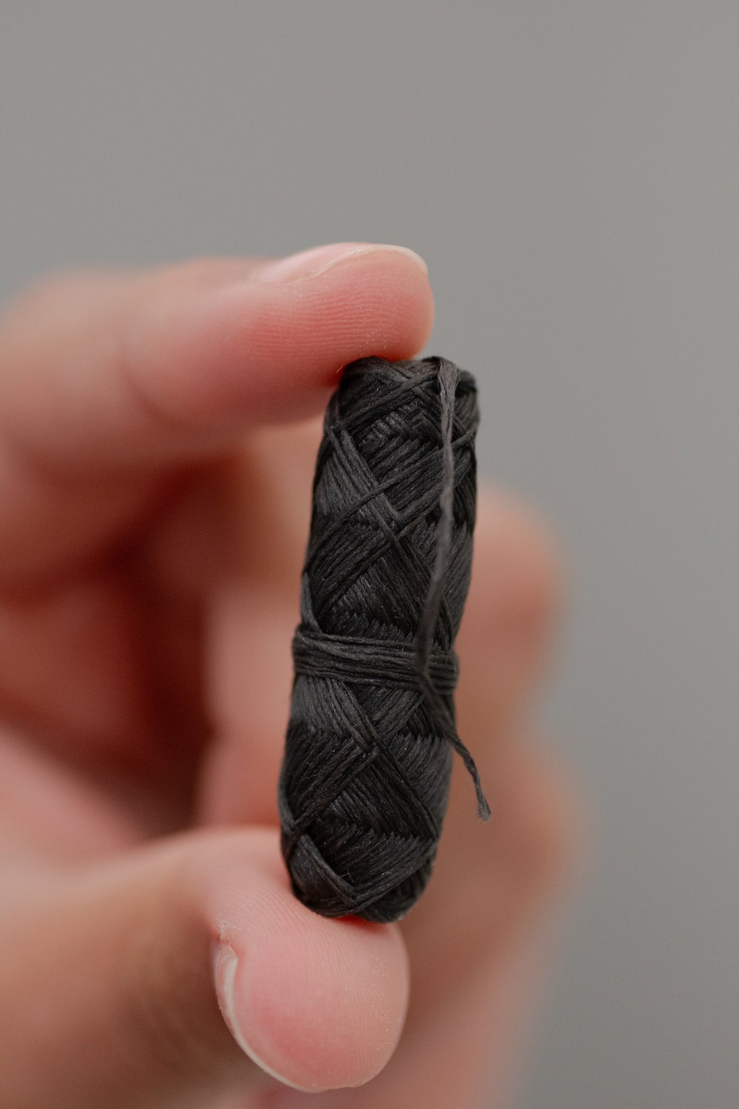 Charcoal dental floss in a bamboo holder by NO TOX LIFE, eco-friendly oral hygiene product with natural bamboo packaging.