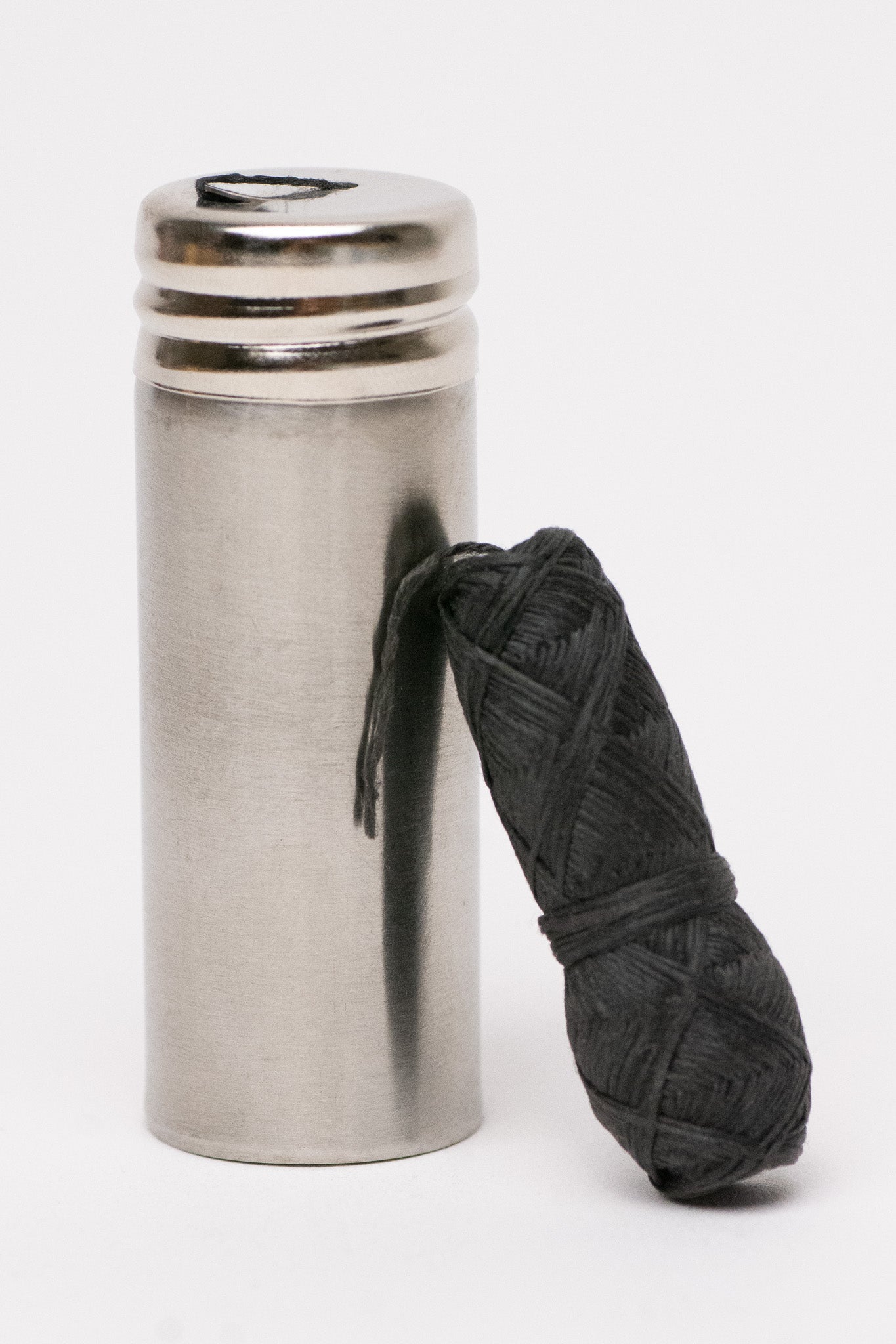 Charcoal floss with stainless steel holder by NO TOX LIFE, displayed on a clean white background.