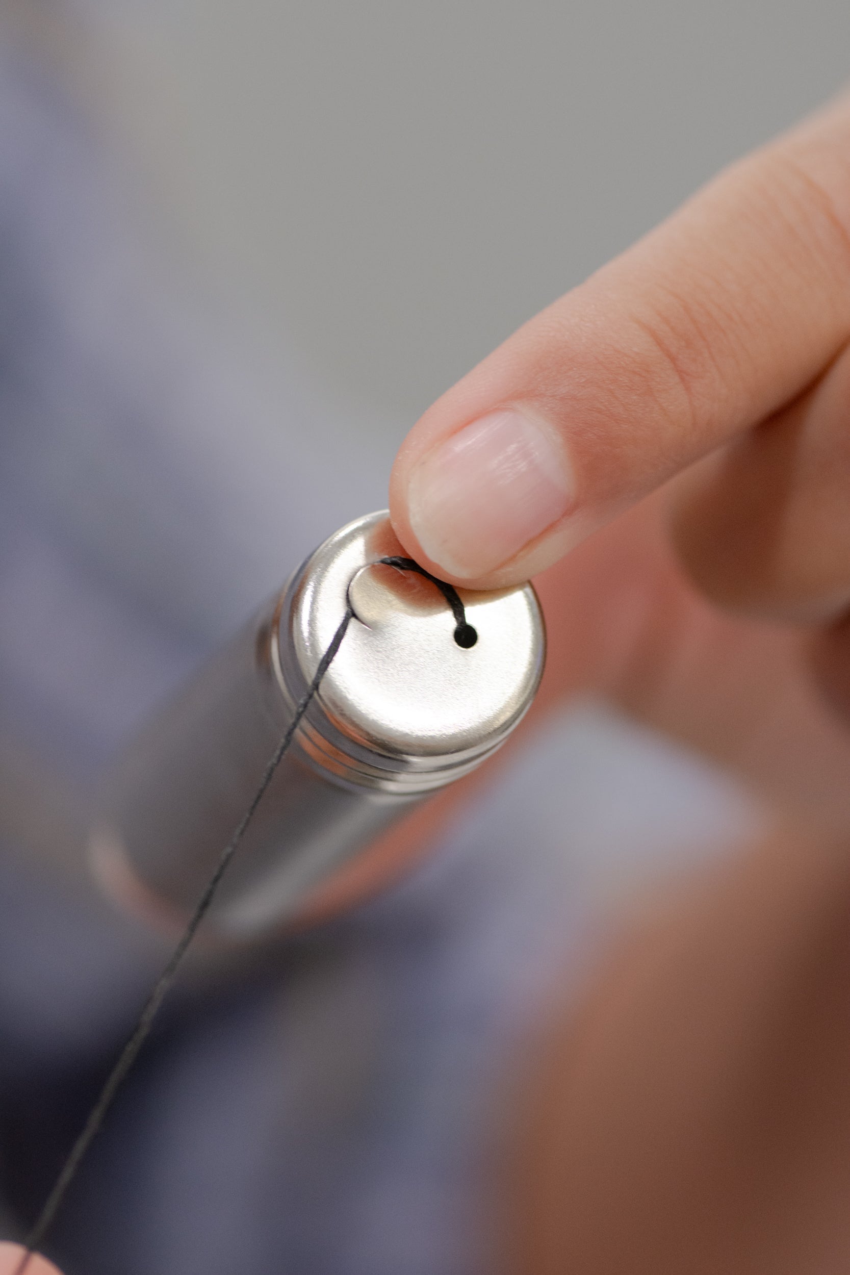Charcoal floss with stainless steel holder from NO TOX LIFE, eco-friendly dental floss in a sleek, reusable container.