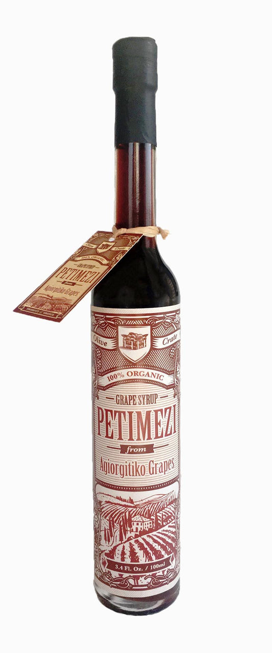 Bottle of Olive Crate 100% organic Petimezi concentrated grape syrup, dark and thick with a natural, rich appearance.