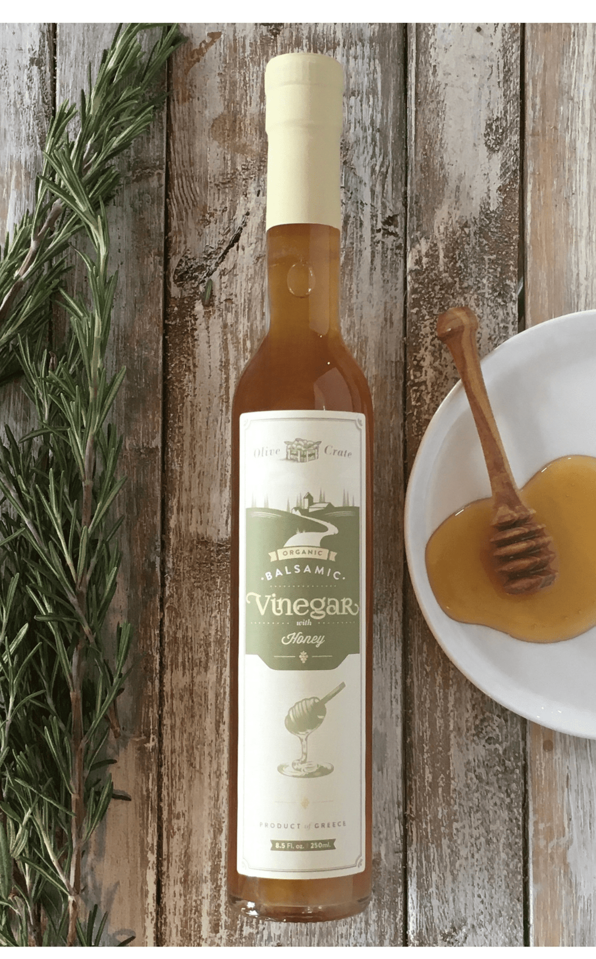 Organic White Balsamic Vinegar with Honey by Olive Crate, featuring a clear glass bottle and Greek Roditis grapes.
