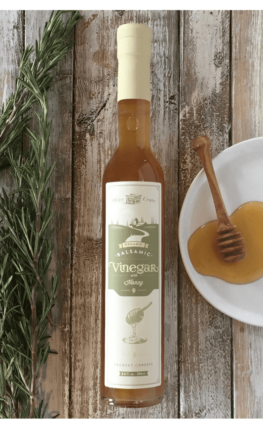 Organic White Balsamic Vinegar with Honey by Olive Crate, featuring a clear glass bottle and Greek Roditis grapes.