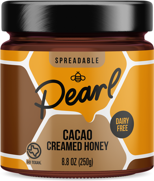 Creamed cacao honey spread by Pearl Honey Spreads, showing smooth, rich cacao-infused honey in a jar.