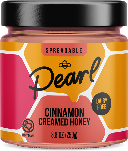 Creamed cinnamon honey from Pearl Honey Spreads in a jar, showcasing smooth, spreadable honey with cinnamon flavor.