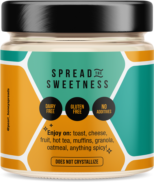Creamed honey by Pearl Honey Spreads in a clear jar, showcasing smooth, spreadable honey with a creamy texture.