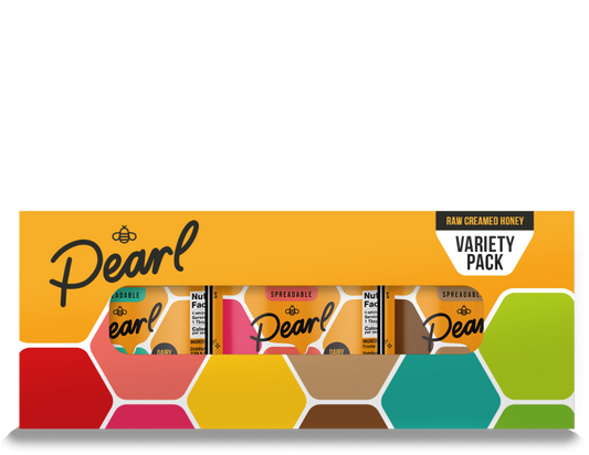 Assorted Pearl Honey Spreads Variety 3 Pack with different flavors in glass jars on a wooden spice rack.