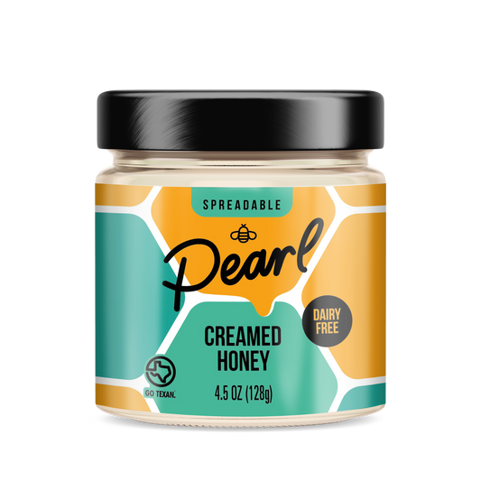 Pearl Honey Spreads Variety 3 Pack featuring assorted flavored honey spreads in clear jars on a spice rack.