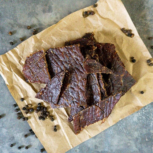 Sliced black pepper beef jerky from Nebraska Star Beef, 1.5 oz slab, showing seasoned dried beef strips with black pepper.