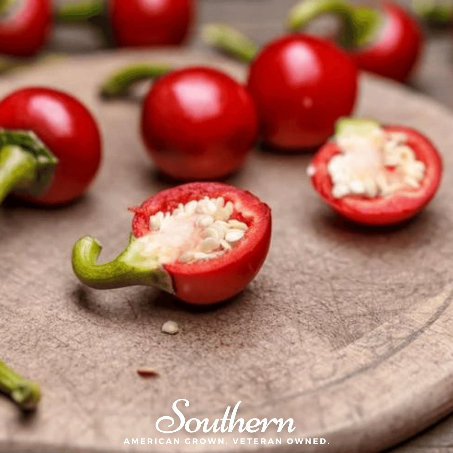 Red Hot Cherry Pepper seeds from Southern Seeds, vibrant red chili peppers and fresh green stems in a close-up image.