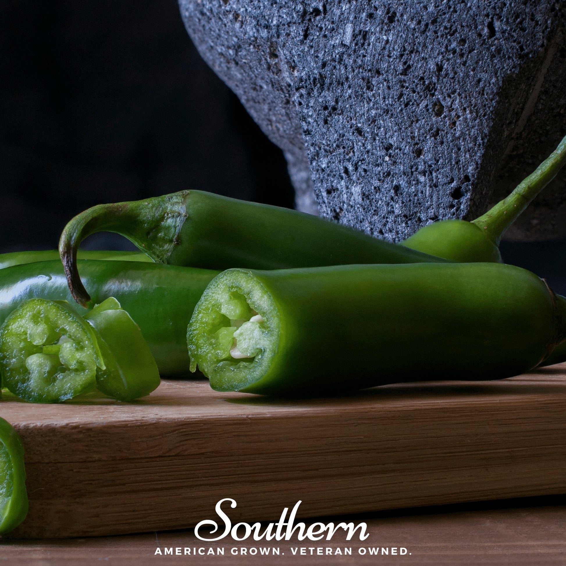 Pack of 25 Serrano Pepper seeds from Southern Seeds featuring vibrant green Serrano Capsicum annuum peppers.