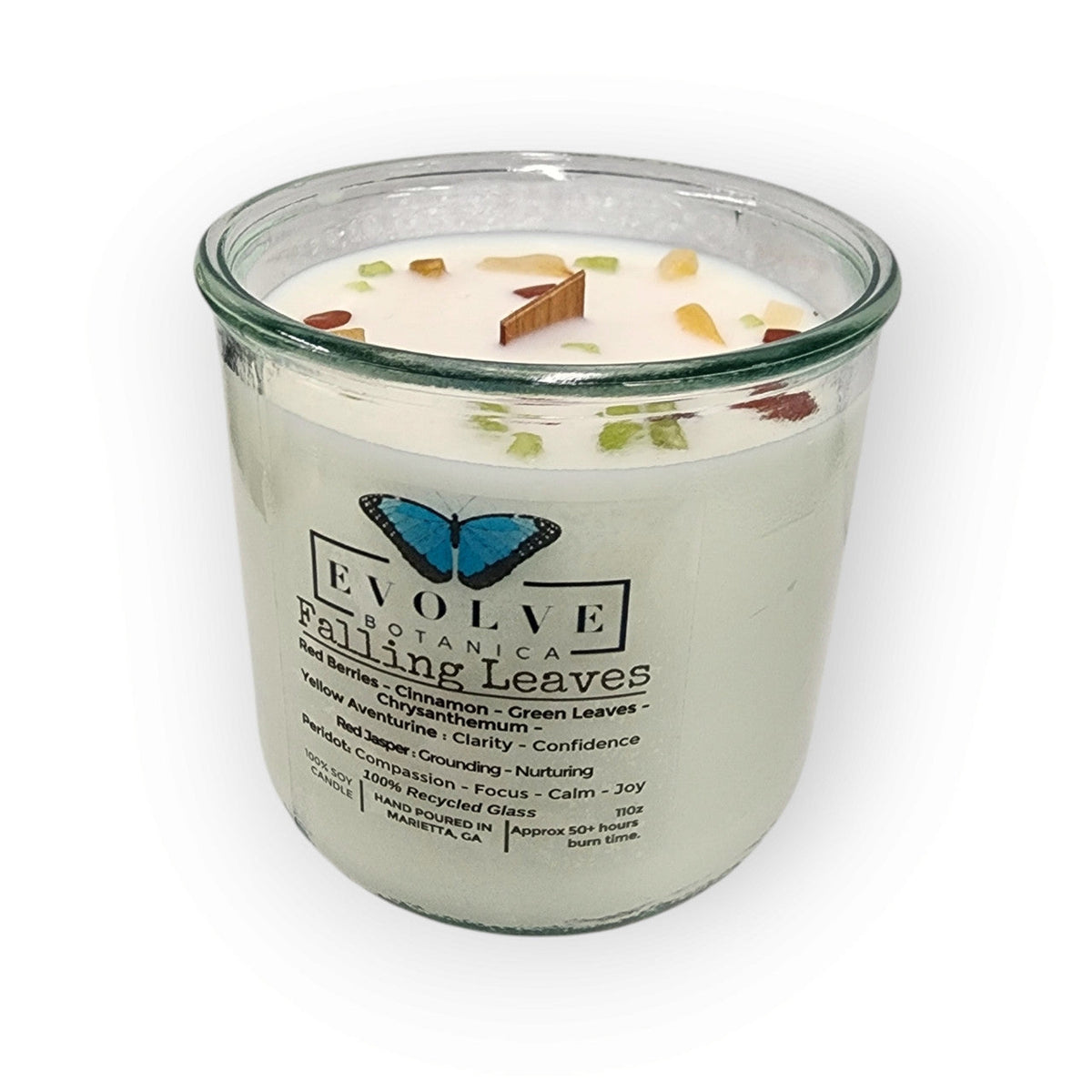 Evolve Botanica Rocks Candle Falling Leaves with wood wick, Peridot, Red Jasper, and Yellow Aventurine gemstones in a soy candle.