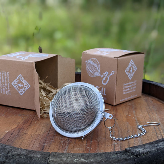 Large Piper Tea Ball from Piper and Leaf Tea Co. shown filled with loose tea leaves, designed for brewing loose leaf tea easily.