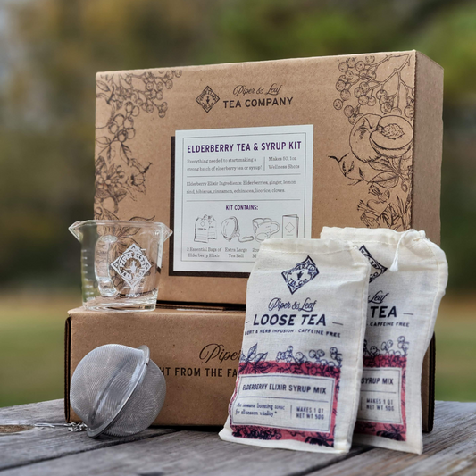 Elderberry syrup starter brewing kit by Piper and Leaf Tea Co. with jars, ingredients, and brewing tools for homemade elderberry syrup.