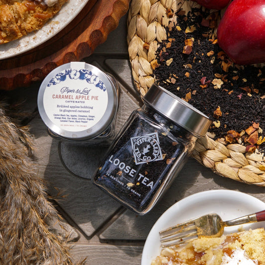 Glass jar of Piper and Leaf Caramel Apple Pie loose leaf tea with a label, showcasing the tea inside.