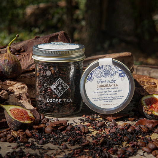 Glass jar of Piper and Leaf Tea Co. Chocola-Tea loose leaf tea, showing dark chocolate-flavored tea leaves inside.