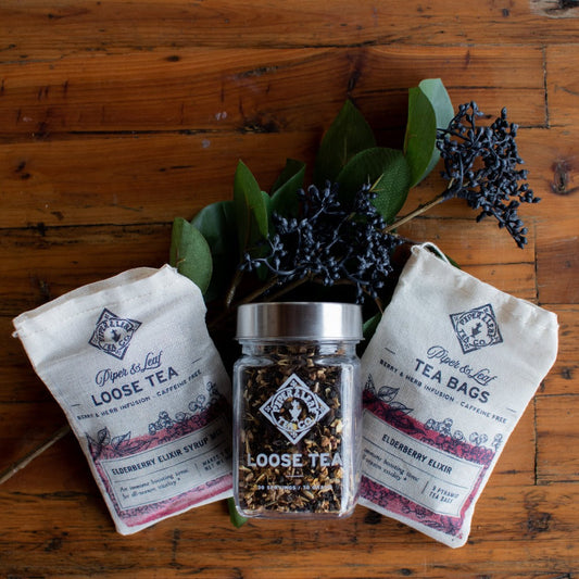 Glass jar of Piper and Leaf Elderberry Elixir loose leaf tea with dried elderberries for 30 servings.