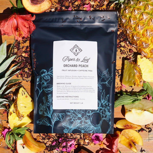Loose Orchard Peach Tea from Piper and Leaf Tea Co. in a pound bag, showcasing fresh peach-flavored tea leaves for brewing.