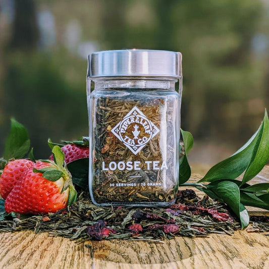 Glass jar of Piper and Leaf Tea Co. Sassyfras Strawberry loose leaf tea with vibrant dried strawberry pieces inside.