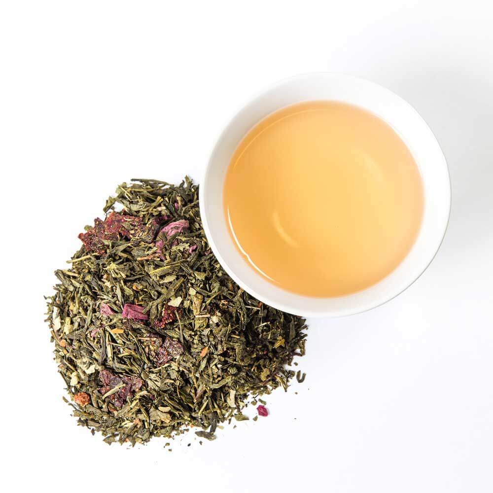 Glass jar of Piper and Leaf Tea Co. Sassyfras Strawberry loose leaf tea with colorful tea leaves visible inside.