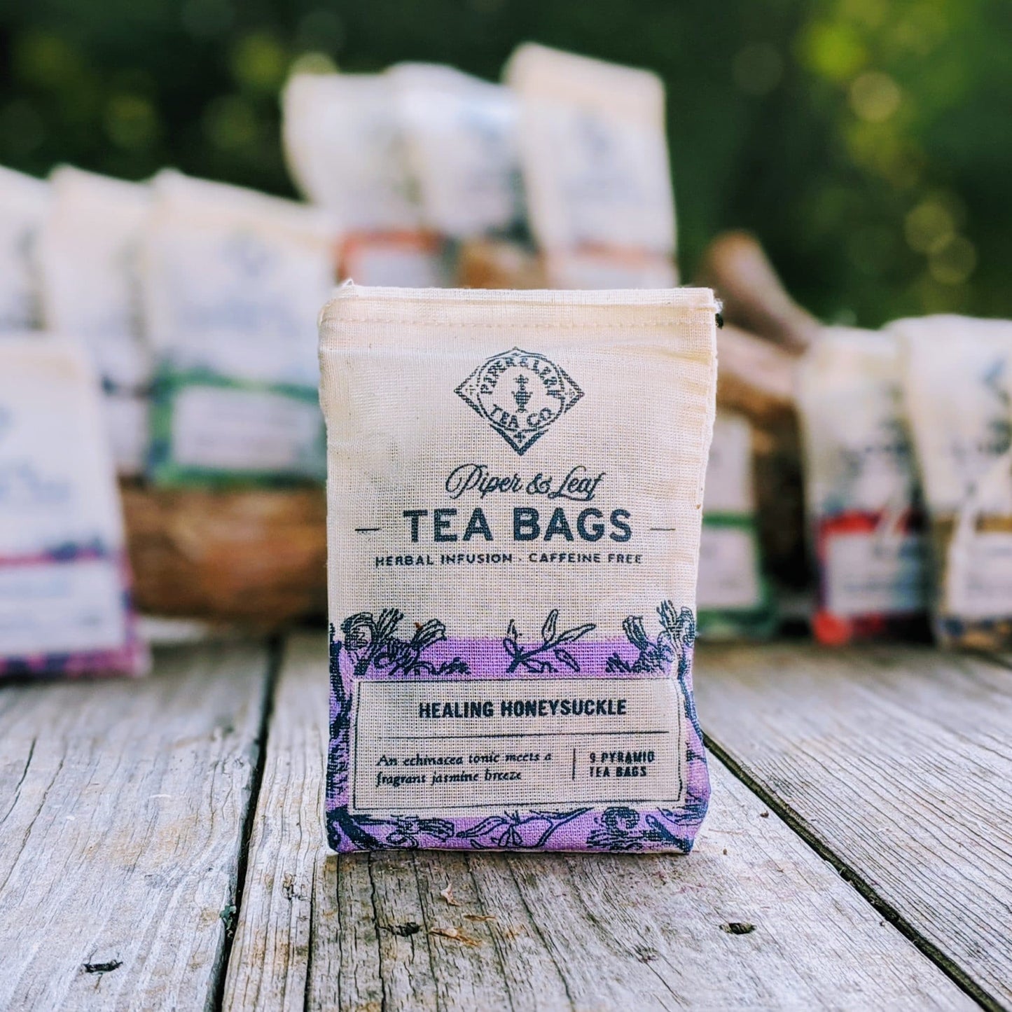 Healing Honeysuckle 9ct tea bags from Piper and Leaf Tea Co. in muslin packaging, showcasing herbal tea bags with fresh honeysuckle flowers.