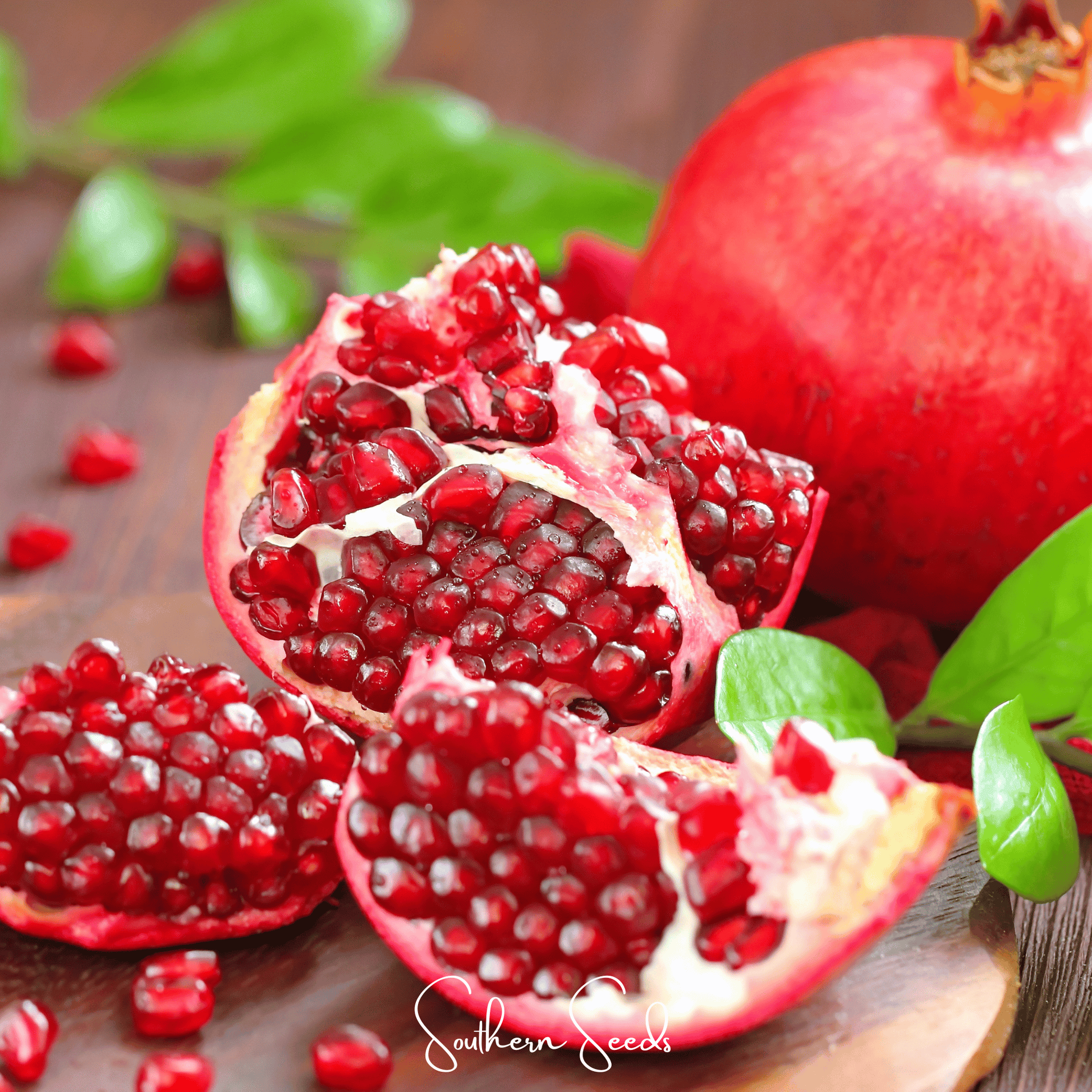 Pomegranate seeds from Southern Seeds, showing a cluster of vibrant red seeds inside a ripe pomegranate fruit.