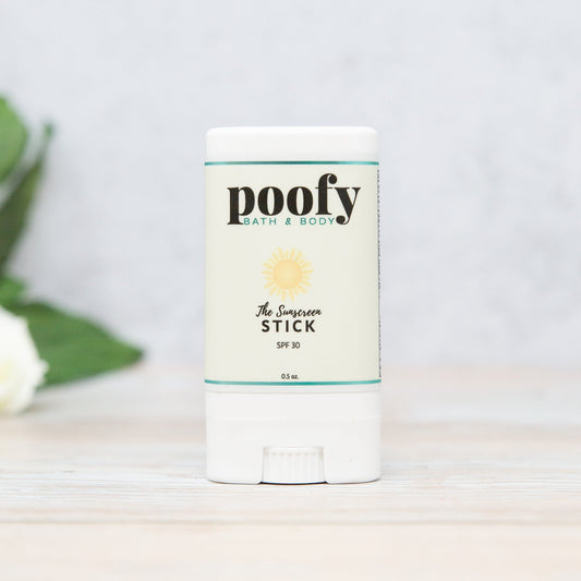 Poofy Organics Sunscreen Stick for outdoor use, featuring a white stick with SPF protection in a natural outdoor setting.