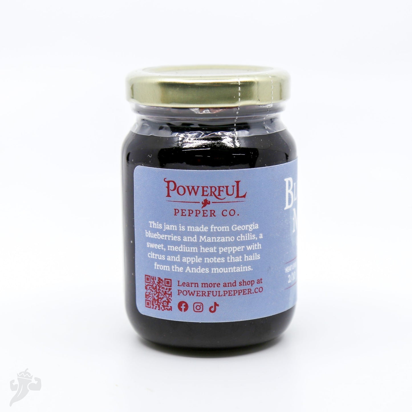 Blueberry Manzano Chili Jam from Powerful Pepper Company, showcasing a jar of vibrant blueberry and chili jelly with fresh ingredients