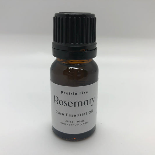 Bottle of Prairie Fire Rosemary Essential Oil in a 10 ml (0.35 oz) dark glass bottle with a white cap.