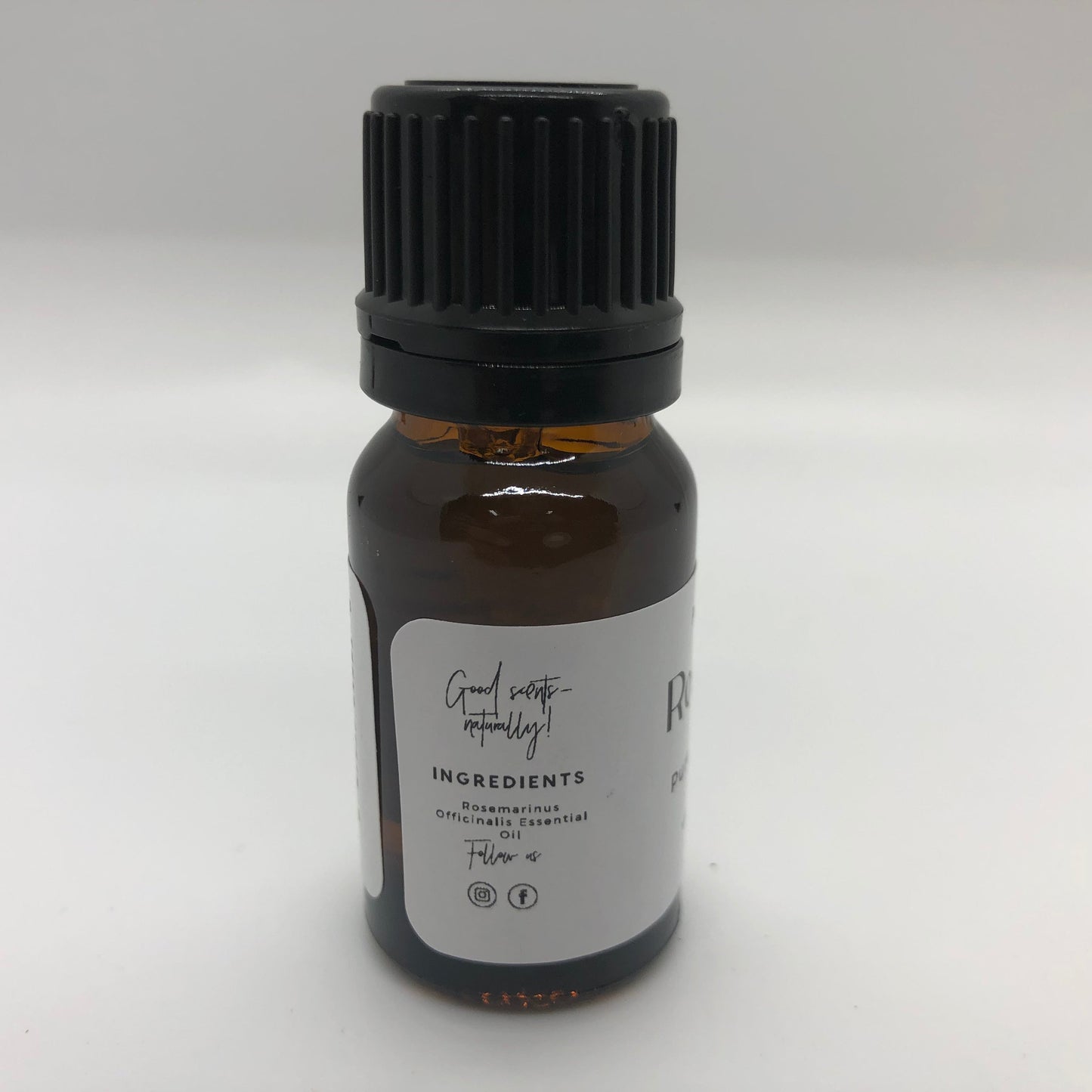 Rosemary essential oil in a 10 ml bottle from Prairie Fire Tallow, Candles, and Lavender, showing the label and oil inside.