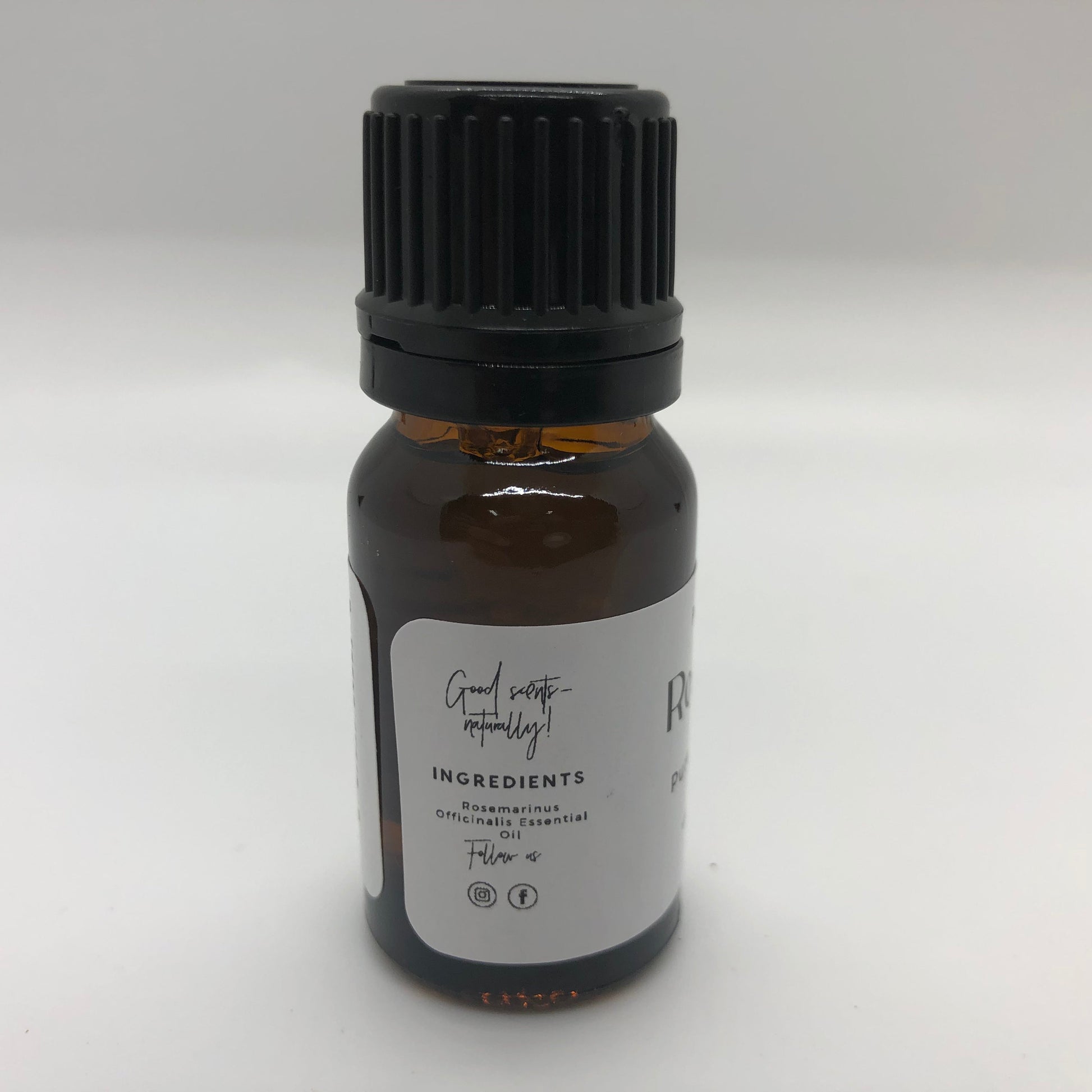 Rosemary essential oil in a 10 ml bottle from Prairie Fire Tallow, Candles, and Lavender, showing the label and oil inside.