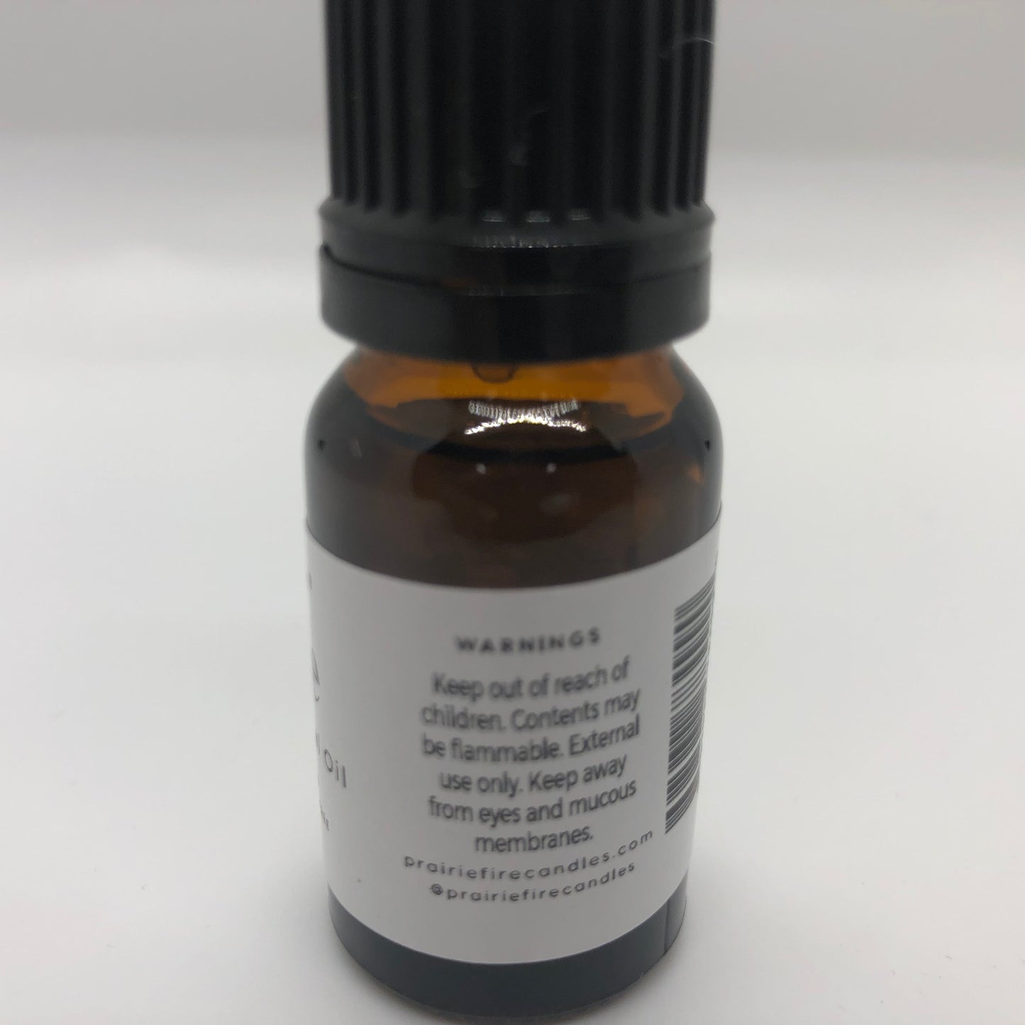 Lime essential oil in a 10 ml bottle from Prairie Fire Tallow, Candles, and Lavender, with fresh lime and essential oil images.