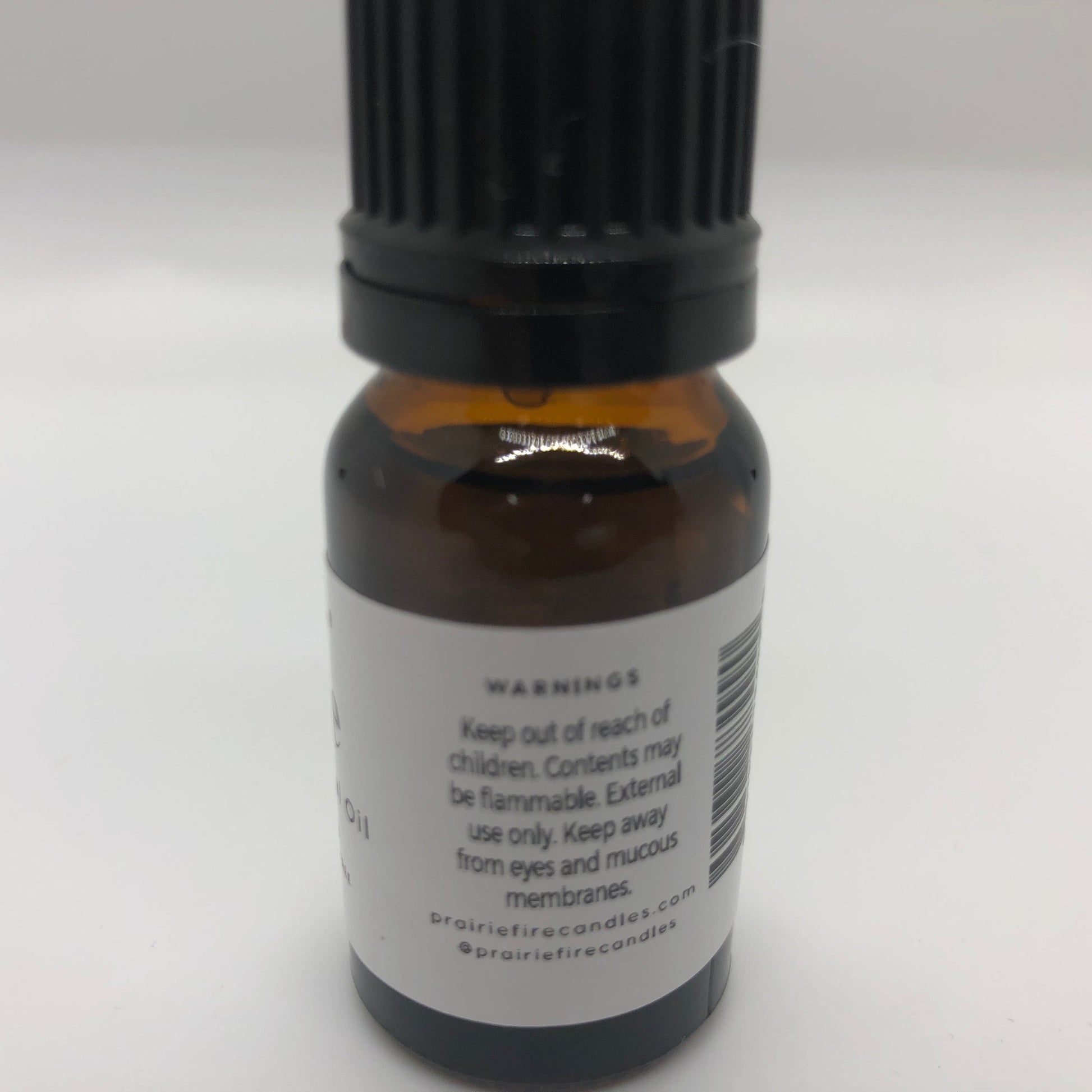 Lime essential oil in a 10 ml bottle from Prairie Fire Tallow, Candles, and Lavender, with fresh lime and essential oil images.