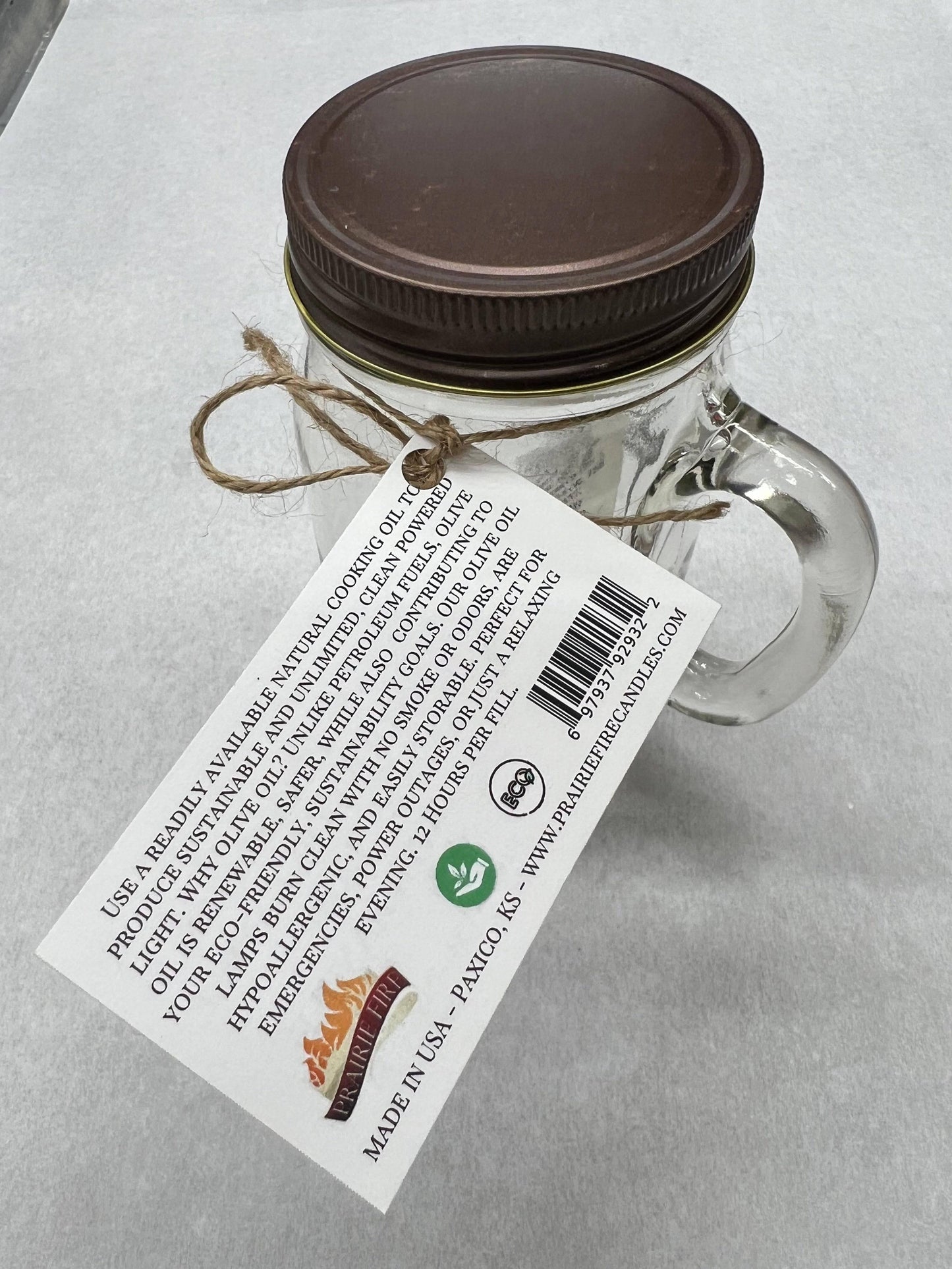 Olive oil candle lamp in a handle mason jar, used as an emergency backup during power outages, by Prairie Fire Tallow Candles.
