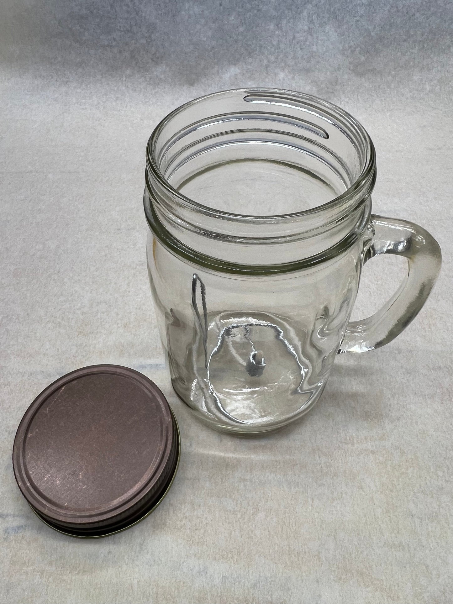 Olive oil candle lamp in a handle mason jar from Prairie Fire Tallow, ideal for emergency power outages.