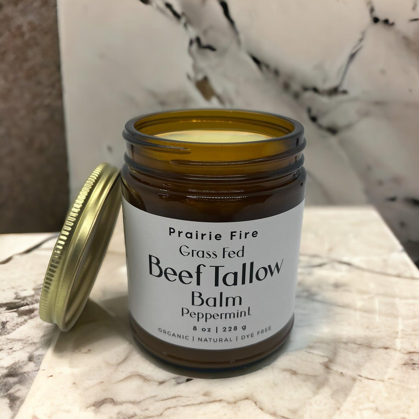 Organic beef tallow balm in an 8 oz jar from Prairie Fire Tallow, moisturizing skin care made in the USA with grass-fed ingredients.