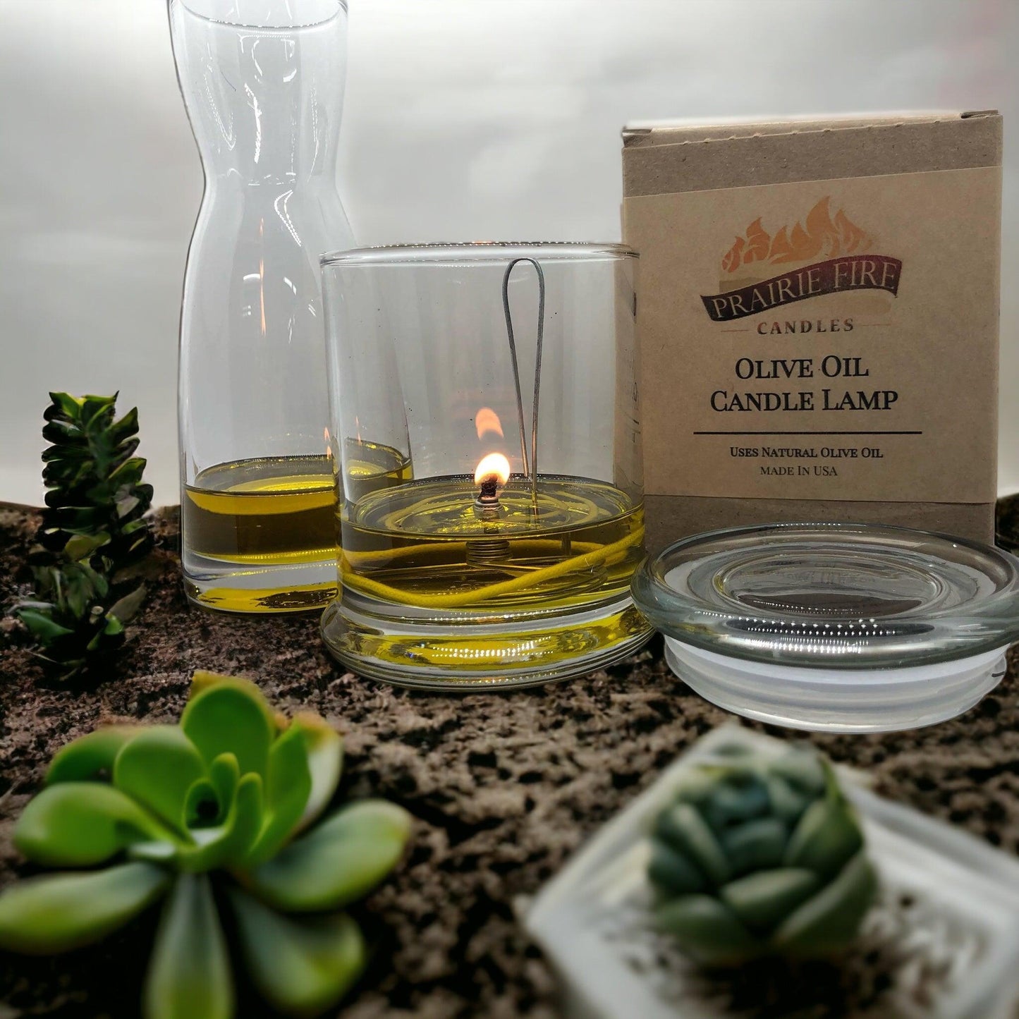 Olive oil candle lamp by Prairie Fire Tallow with a glass reservoir, designed as an emergency backup for power outages.