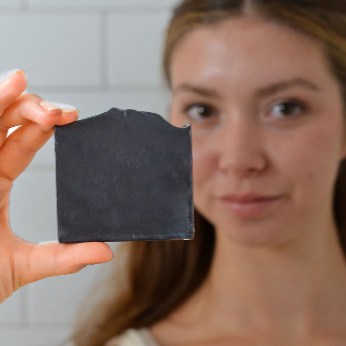Handmade Clarifying Charcoal Bar Soap by Pretty Farm Girl with tallow and goat milk, showing a natural soap bar with a rustic appearance.