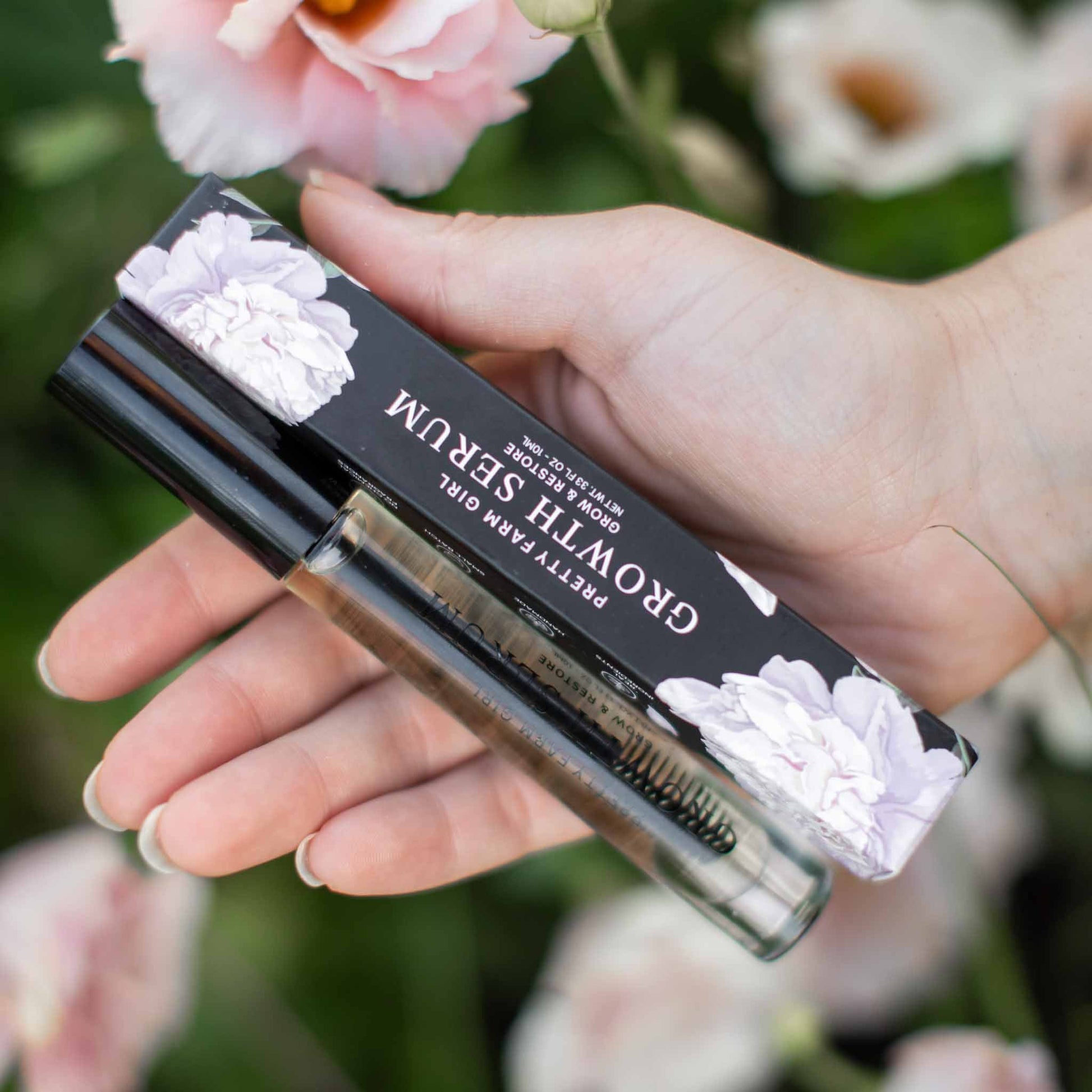 Pretty Farm Girl eyelash and eyebrow growth serum bottle, showcasing the eyelash serum for thicker, longer lashes and brows.