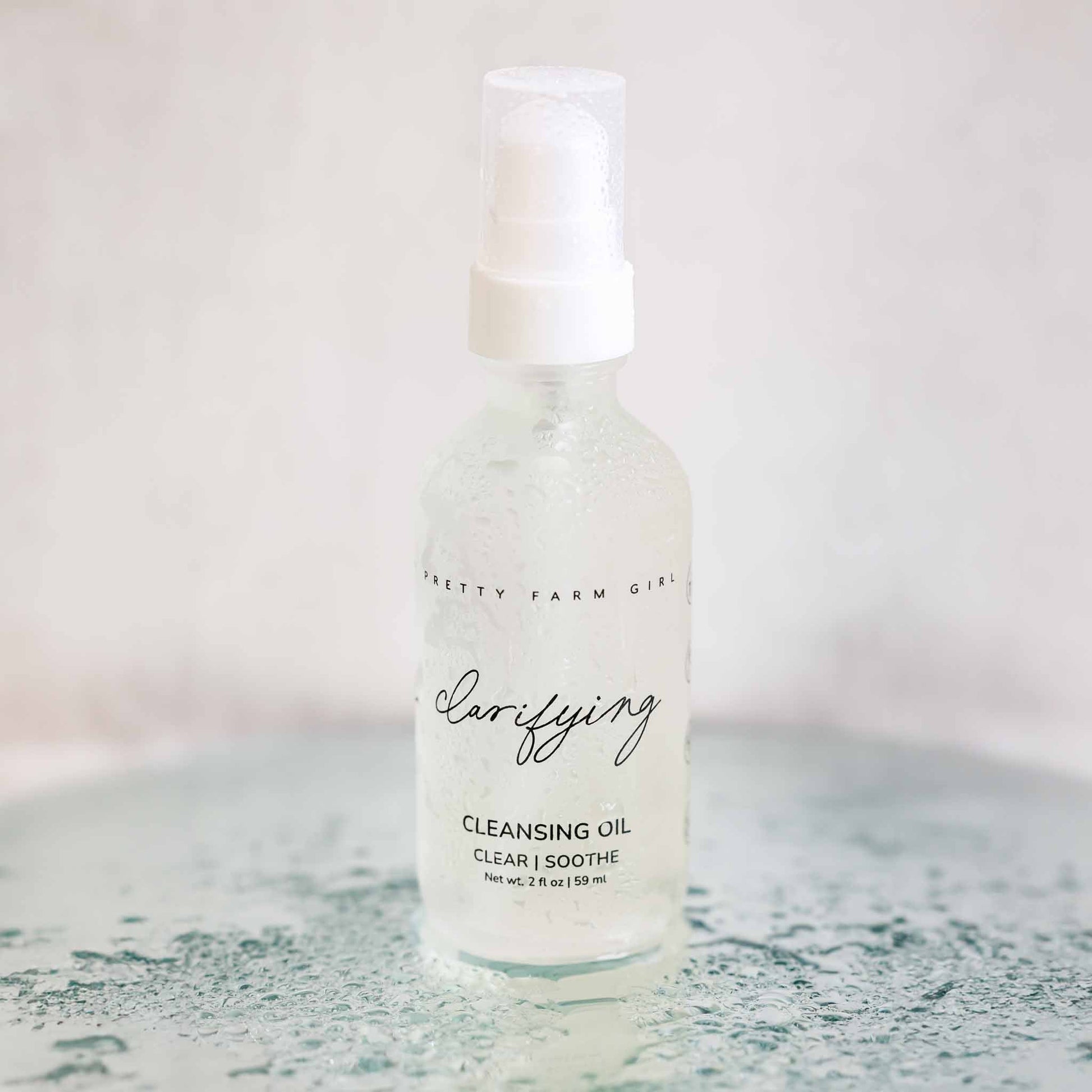 Pretty Farm Girl Clarifying Cleansing Oil for acne-prone skin, face cleanser with natural ingredients, in a clear bottle.