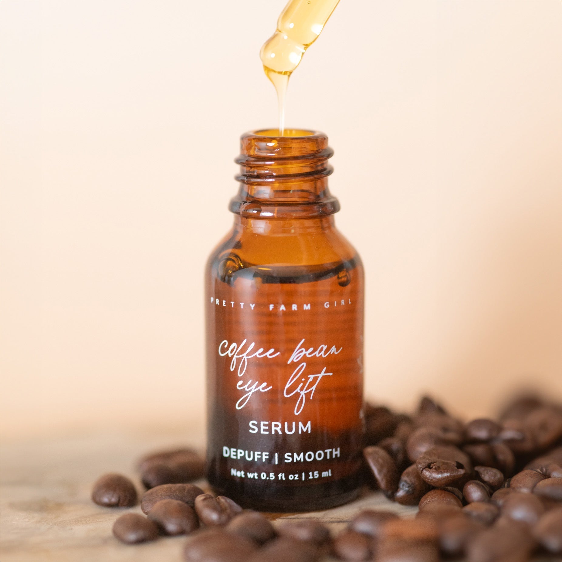 Pretty Farm Girl Coffee Bean Eye Lift Serum in a sleek face serum bottle, designed to reduce puffiness and brighten the eye area.