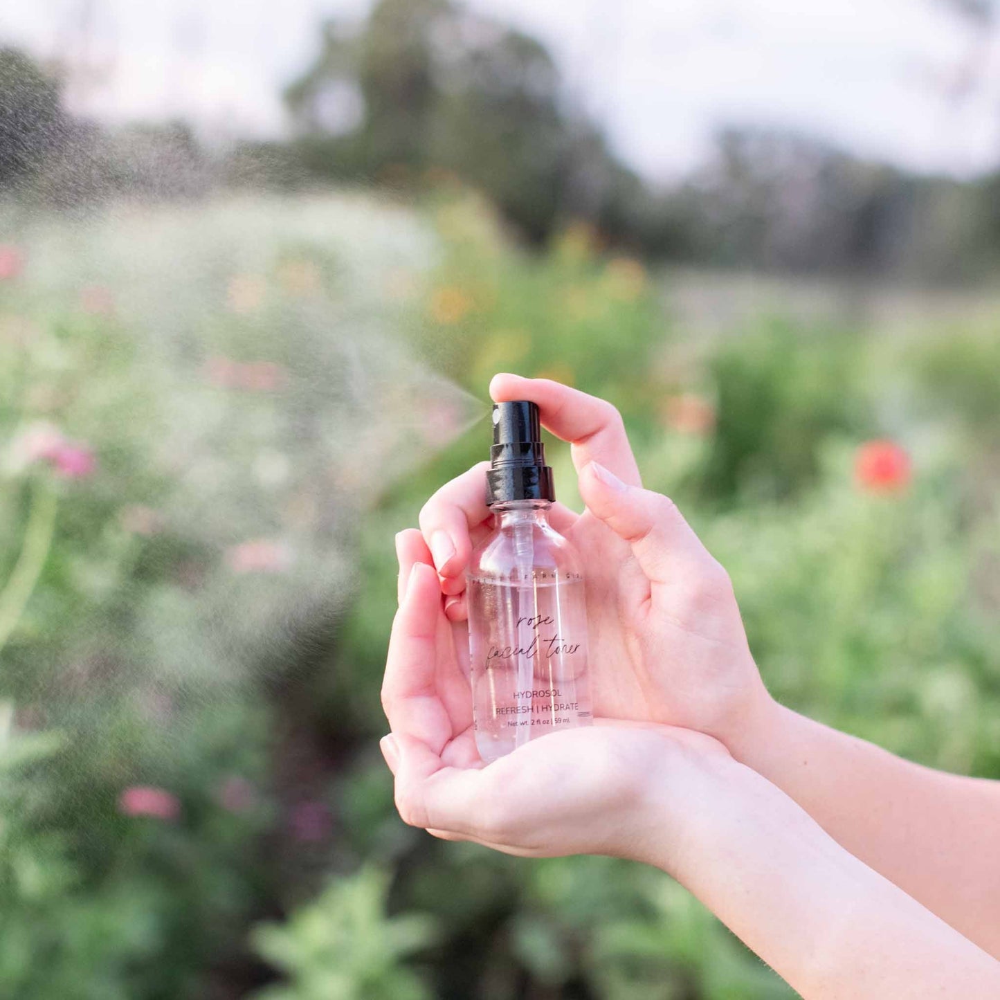 Organic Pretty Farm Girl Rose Facial Toner in 2 oz bottle, natural skincare product with pure rose extract for gentle facial refreshment.