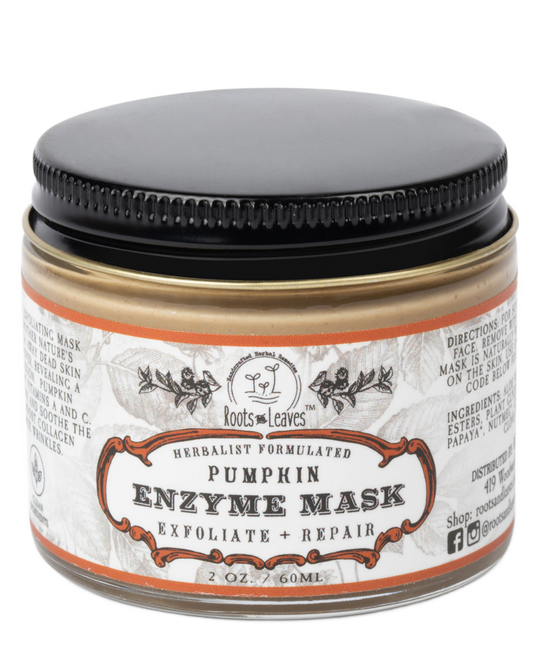 Creamy pumpkin enzyme face mask by Roots and Leaves LLC, shown in a jar with fresh pumpkin slices and natural ingredients.