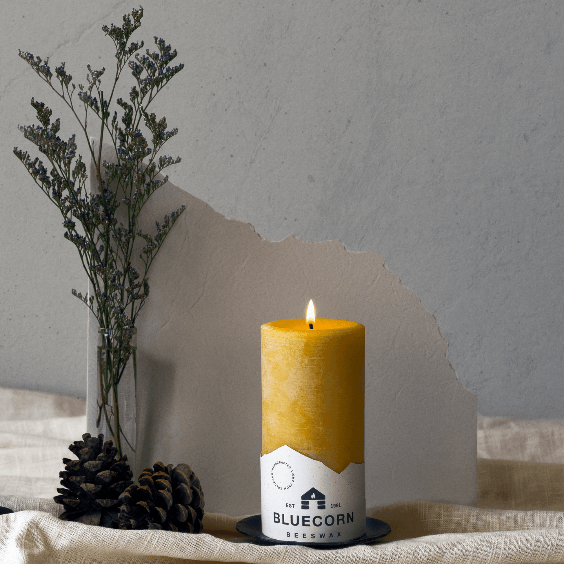 Set of blue beeswax pillar candles by Bluecorn Candles, showcasing natural, smooth-textured beeswax pillars on a clean surface.